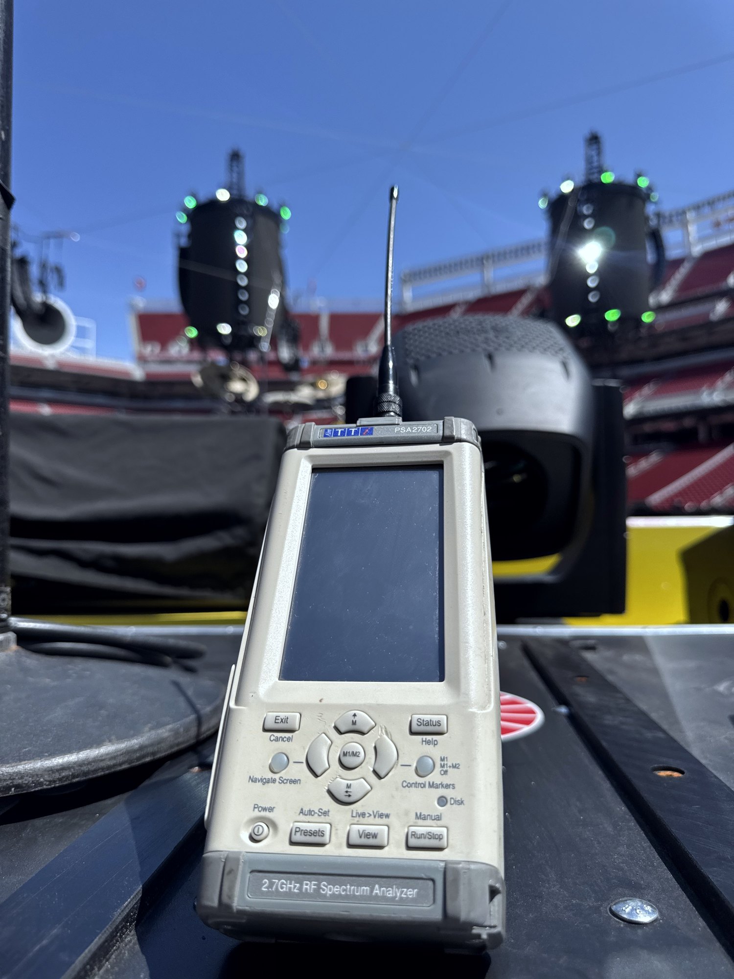 Spectrum analyzer on stage with audio line arrays during large-scale venue RF coordination