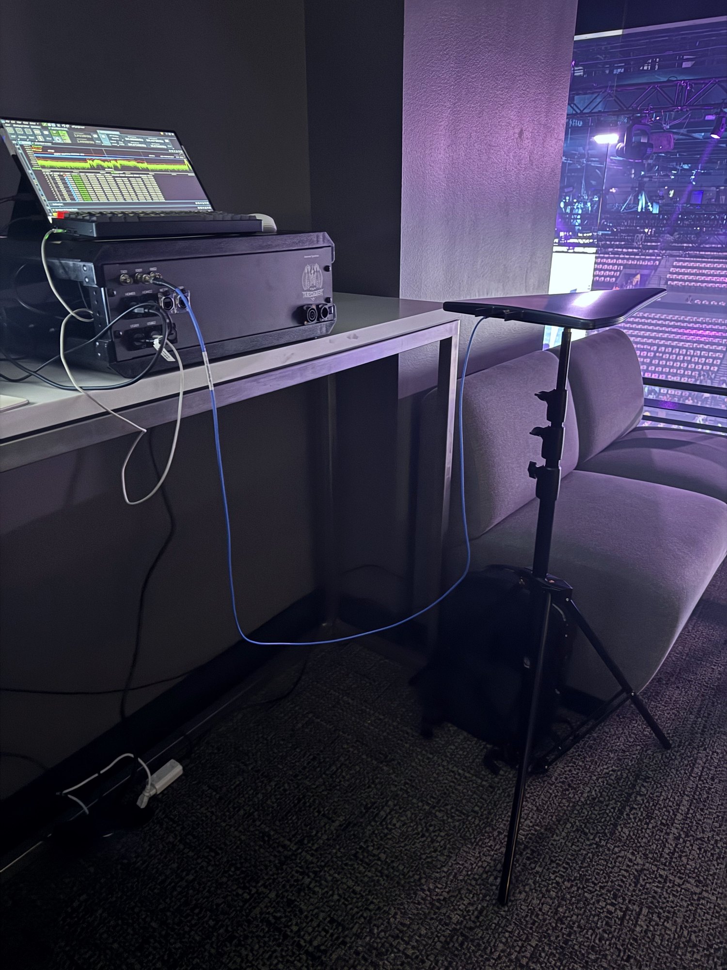 Show AV control deck with confidence monitor and rack at a venue